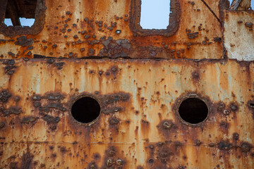 Detail view of abandoned ship carcass in graveyard ships on the atlantic ocean coast