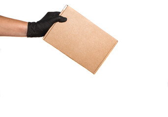 Hand with black gloves delivering a package in a cardboard box, home delivery, donation concept.