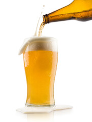 pouring blonde beer into glass with splashing foam, on white background