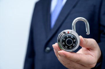 Businessman holding a lock. Business security concept.