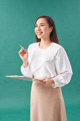 Young Asian business woman holding a paper isolated on turquoise