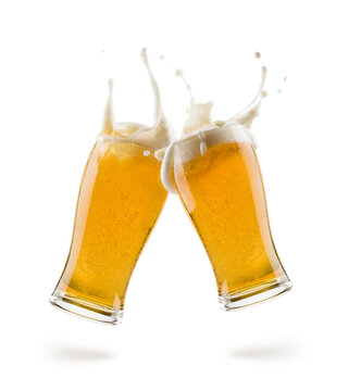 two glasses of lager beer bumping on white background with shadow