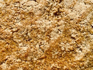 Closeup and top down view of a rustic and traditional homemade flapjack. Ingredients are golden syrup, unsalted butter and rolled porridge oats. Easy recipe, home baked tasty sweet treat filling frame