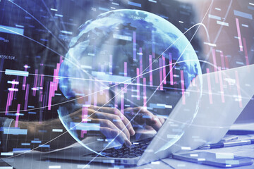 Fototapeta na wymiar Double exposure of market chart with man working on computer on background. Concept of financial analysis.