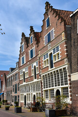 Fototapeta na wymiar Hoorn, the Netherlands - May 2020. Old leaning facades on the Veermanskade of the historic town of Hoorn in North Holland.
