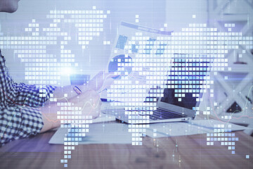 Multi exposure of businessman working on laptop on background. International business hologram in front. Concept of success.