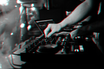 DJ mixes music on a professional controller Board in a nightclub at a party