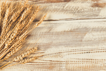 Ears of wheat and wooden surface with blank copy space.
