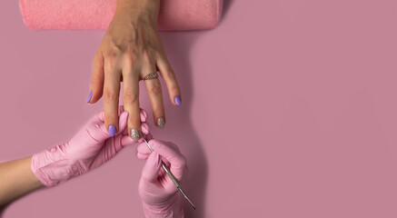 Manicure process on pink background, top view.Manicure in beauty salon.Manicure concept,banner