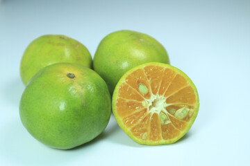 Green orange fuit on white background.
