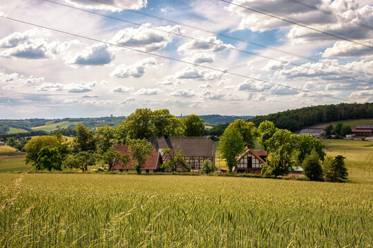 German rural landscape near Velbert Langenberg with fields and hills and a Farm in Background