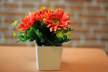 A small flower pots placed on a table in a coffee shop.