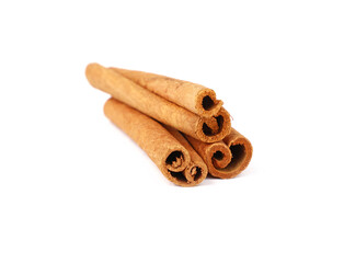 Close up three cinnamon sticks isolated on white