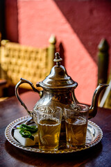 Fototapeta na wymiar A teapot of mint tea in one of the many cafees on Jemaa el Fnaa square in Marrakech, Morocco. 