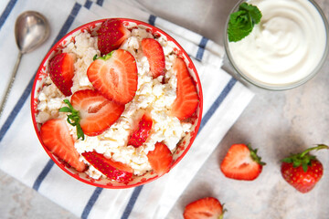 Cottage cheese with strawberries and sour cream. Healthy dessert. Top view