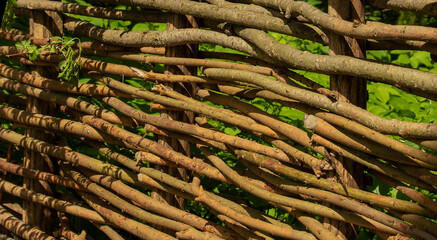 Wicker fences are a lightweight building material made from thin branches.