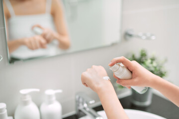 Obraz na płótnie Canvas Body care concept. Woman applying moisturizing hand cream on hands and nails after shower.