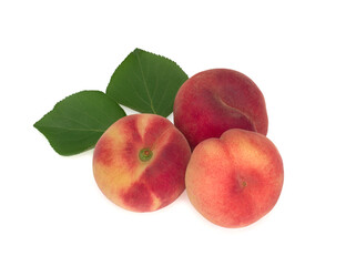 Three fig peaches with leaves isolated on white