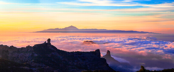 Grand Canary island. Mirador Roque Nublo . Breathtaking  mountains over sunset and view of Tenerife . - obrazy, fototapety, plakaty