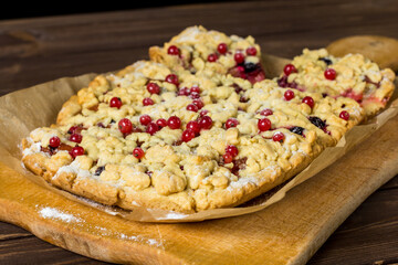 sliced ​​homemade grated pie with berries