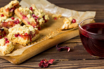 tasty breakfast. sliced ​​homemade grated pie with berries on a wooden board.