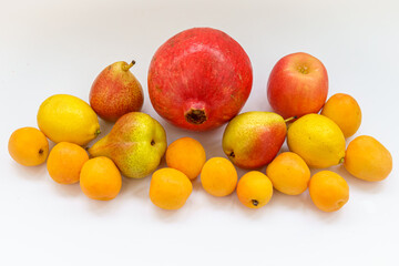 Composition of delicious ripe yellow apricots, apples, pears, pomegranate
