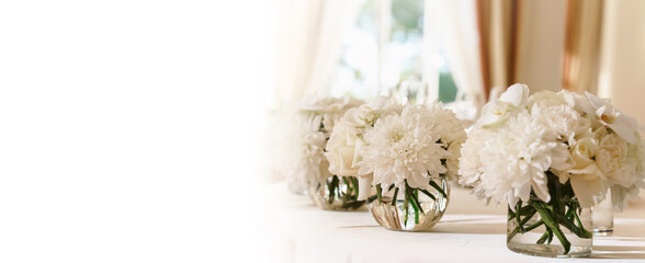 Wedding flower arrangements and decorations. Empty copyspace with white background and space for text. Holiday accessories and backgrounds