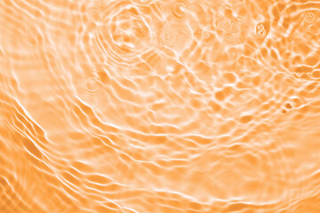Blue splashing  orange cosmetic moisturizer, micellar water, toner, or emulsion background