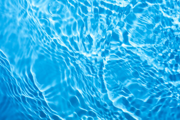 Fototapeta na wymiar Blue splashing blue cosmetic moisturizer, micellar water, toner, or emulsion background