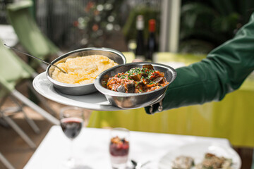 A waitress bringing dishes in a French restaurant.
Meal, dinner in a restaurant