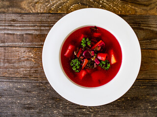 Borsch - beetroots soup on wooden table