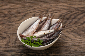 Anchovies in the bowl served basil leaves
