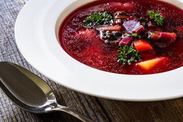 Borsch - beetroots soup on wooden table