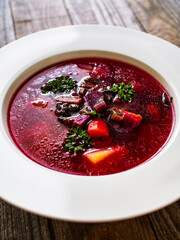 Borsch - beetroots soup on wooden table