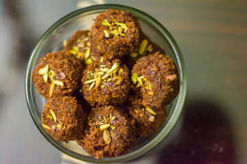 Fresh Homemade ladoo or laddu, made by bread crumbs with pistachio on it, with selective focus

