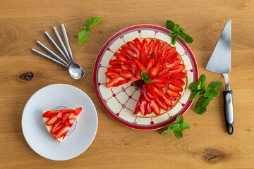 Strawberry pie on a wooden table with mint leaves