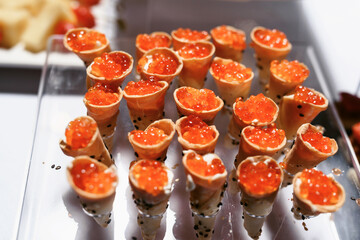 Catering table set service various snacks on a table at banquet. Set of cold snacks, canape, beverages, closeup. Side view. Banquet table