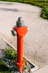 Fototapeta na wymiar Red high fire hydrant on the street.