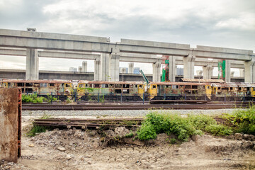 The old locomotive and The sky train being built.