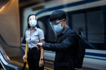 Asian people are on the subway. They wear masks to protect against viruses.