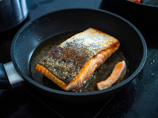 Cooking salmon steak on frying pan
