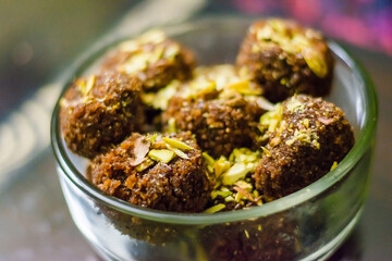 Fresh Homemade ladoo or laddu, made by bread crumbs with pistachio on it, with selective focus
