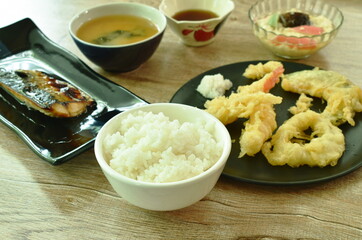 plain rice eat couple grilled Saba fish and tempura with miso soup Japanese food set on table