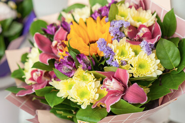 Colorful flower bouquet on the shelf. Flower business. Multi-colored bouquet. Selective focus. Macro photo.
