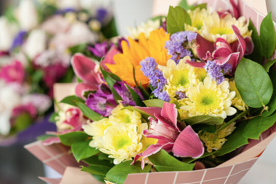 Colorful flower bouquet on the shelf. Flower business. Multi-colored bouquet. Selective focus. Macro photo.