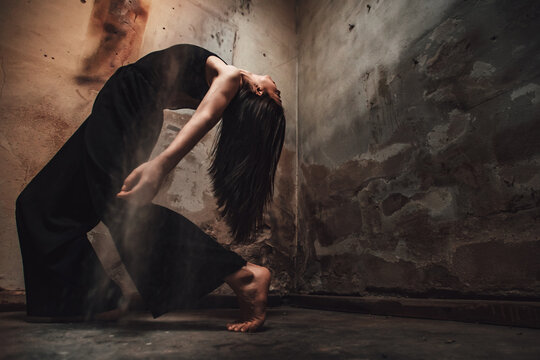 contemporary woman dancer backbend with long hair