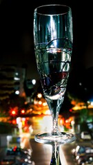 Glass with mirror image on a dark rainy night