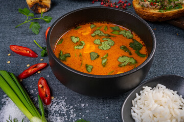 Stew soup with meat, potatoes, mushrooms and red pepper in bowl