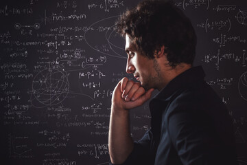 Human intellect. Training and research, concept. Pensive man and physical and mathematical formulas