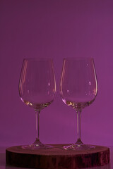 Two glasses of wine on violet background, warm tone,